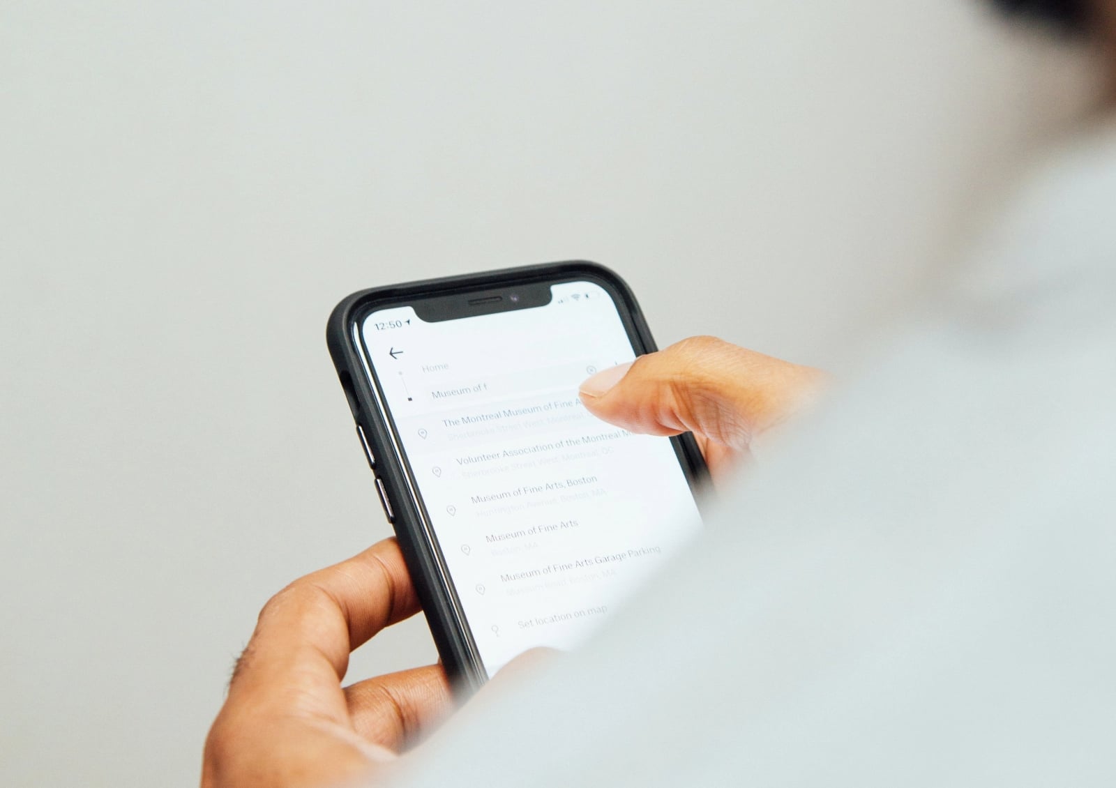 Custom mobile app development in Malaysia: user holding a smartphone app